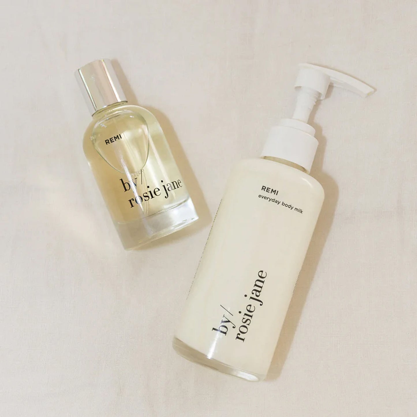Two REMI skincare products from 'by Rosie Jane' on a light background