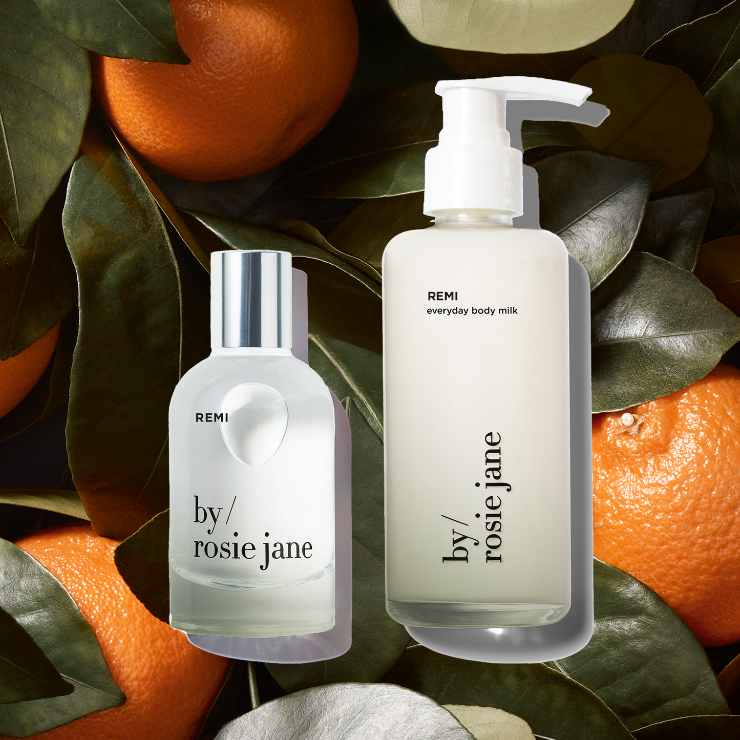 remi perfume and remi body milk from 'by Rosie Jane' on a background of oranges and leaves.