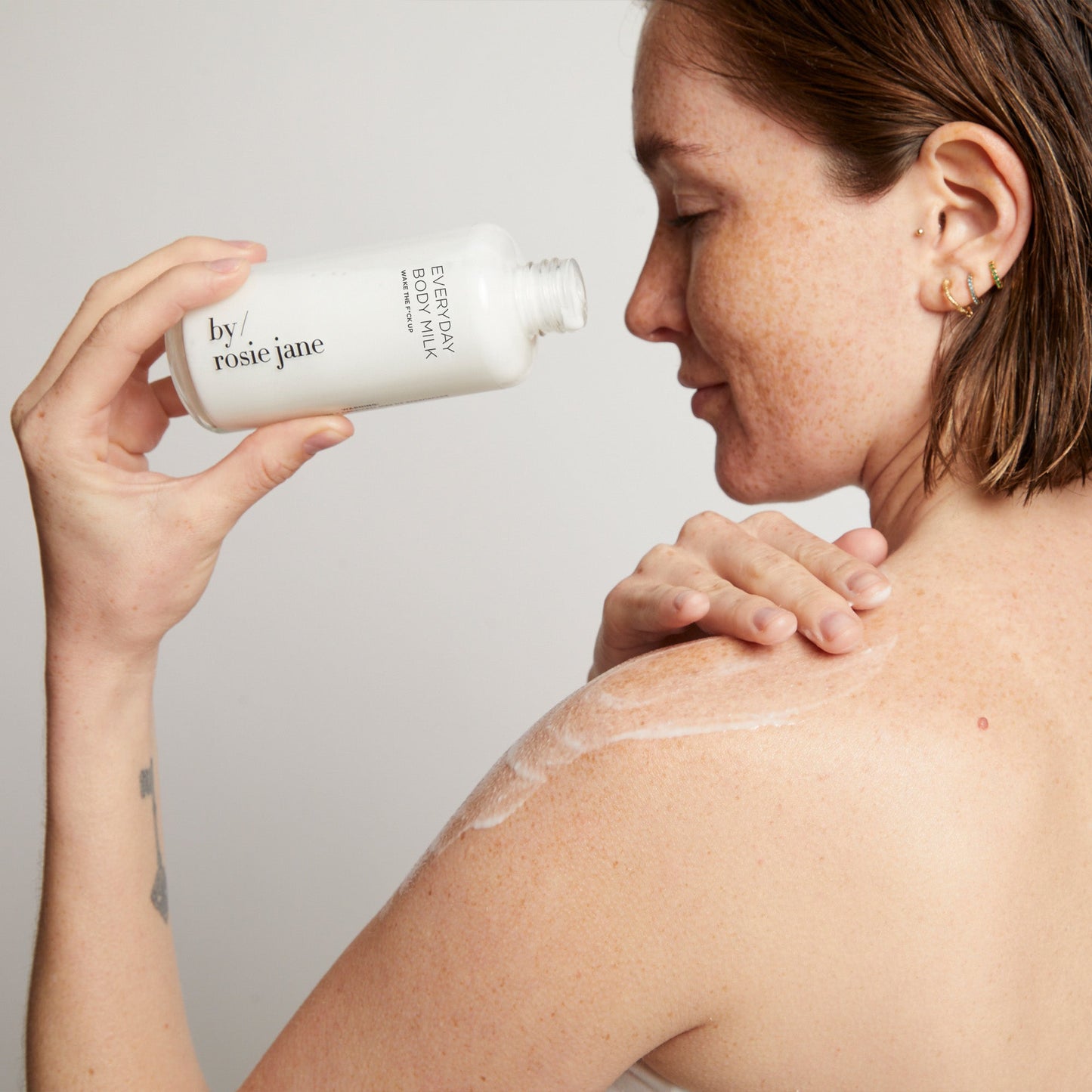 woman applying body milk on body