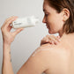woman applying body milk 