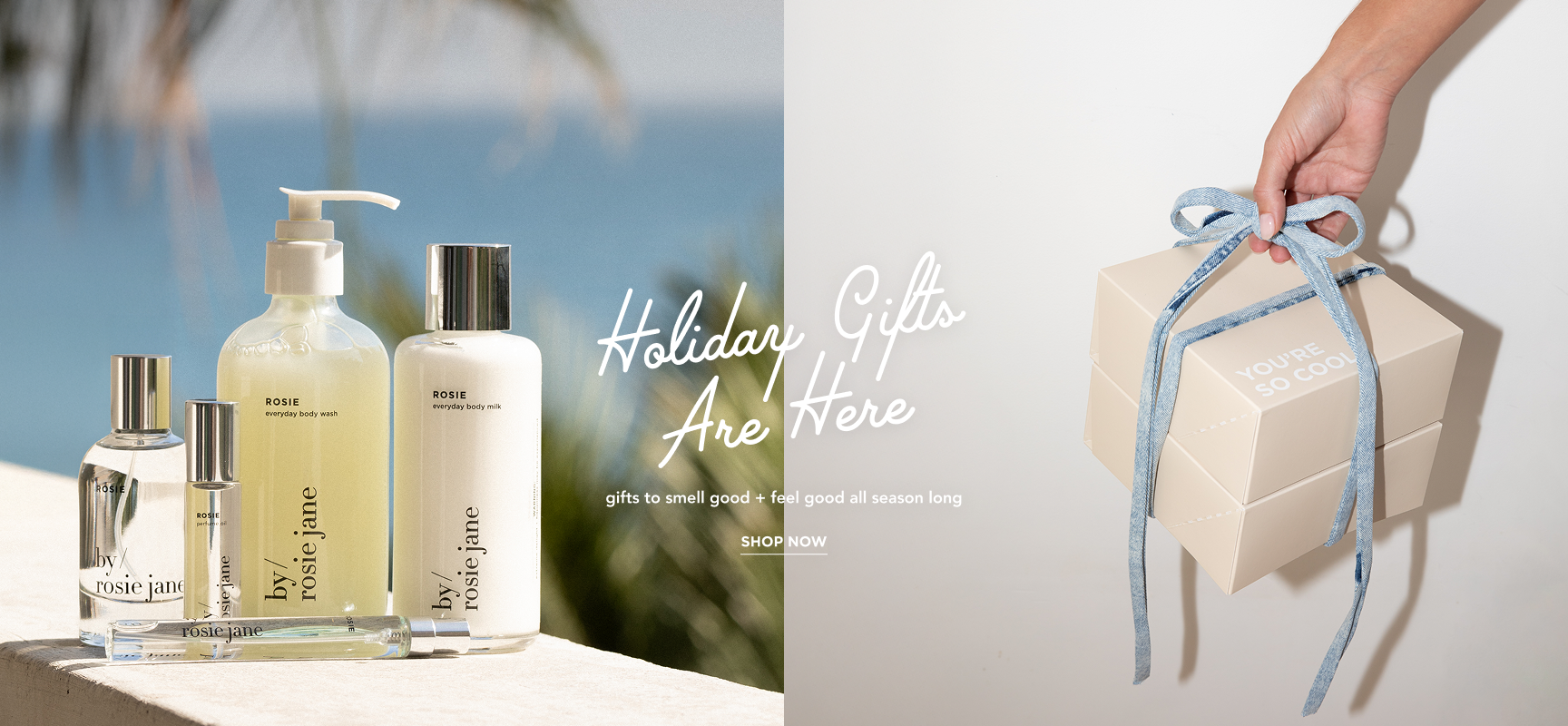 side by side image. on the left a collection shot of rosie perfume, body wash, body milk, perfume oil, and travel spray. on the right, someone holding two gift boxes tied together with a denim ribbon. copy on top reads: holiday gifts are here. gifts to smell good + feel good all season long. shop now.