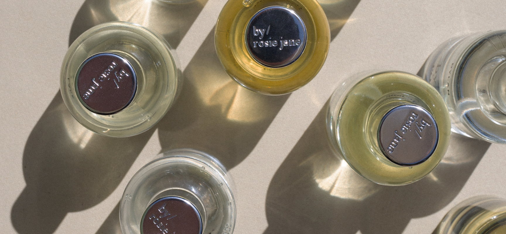 top down image of by/ rosie jane perfume bottles