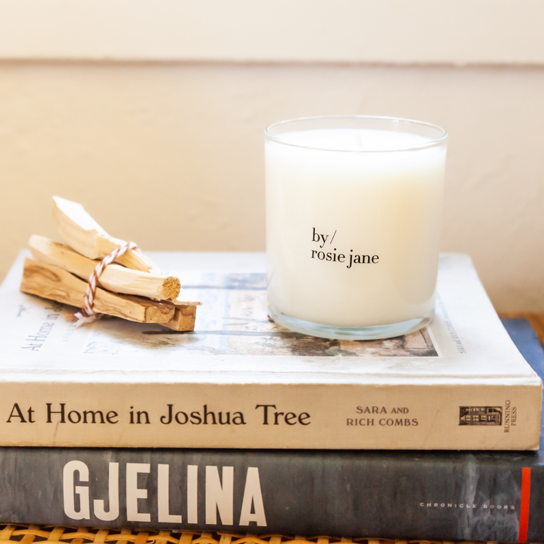 a by/rosie jane candle on a stack of books. 