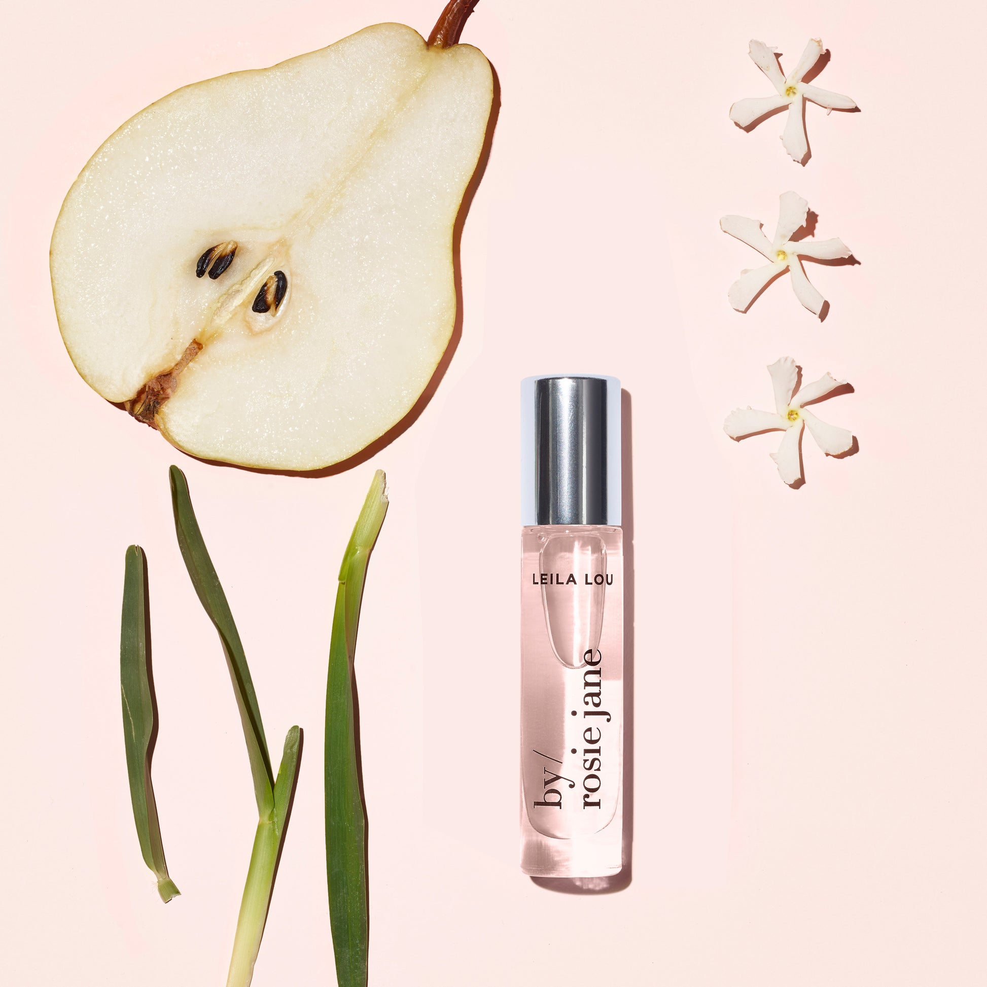leila lou perfume oil with notes: pear, jasmine, and fresh cut grass.